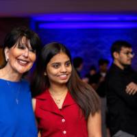 President Mantella smiles and poses with a grad